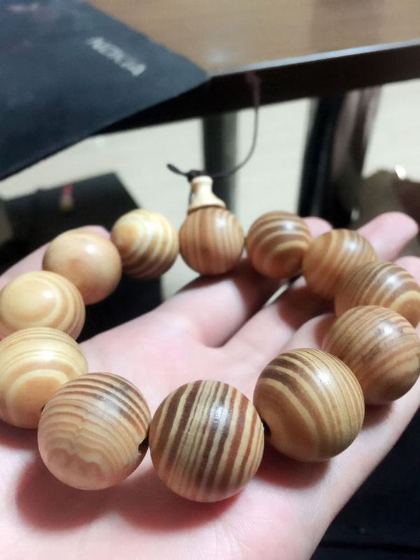 麻烦大家帮我看看这手串是什么木,有一股很浓的松油味,刚拿回来的时候